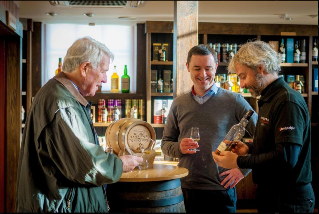 Three person are drinking Whiskey in Scotland