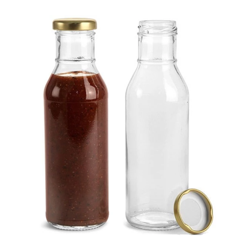 Glass sauce bottle with twist-off cap and clear empty condiment bottle